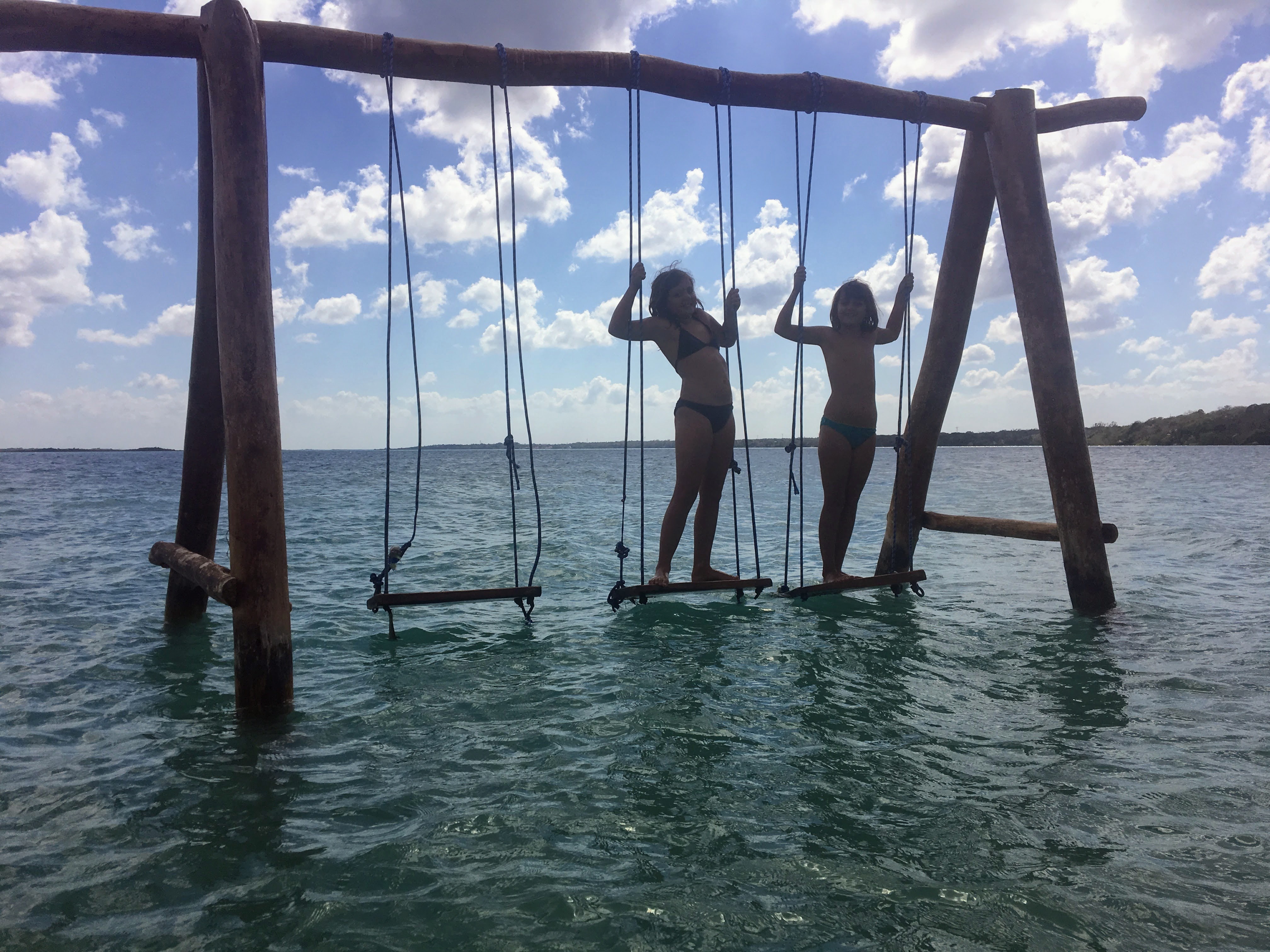 Kids on a swing by the water